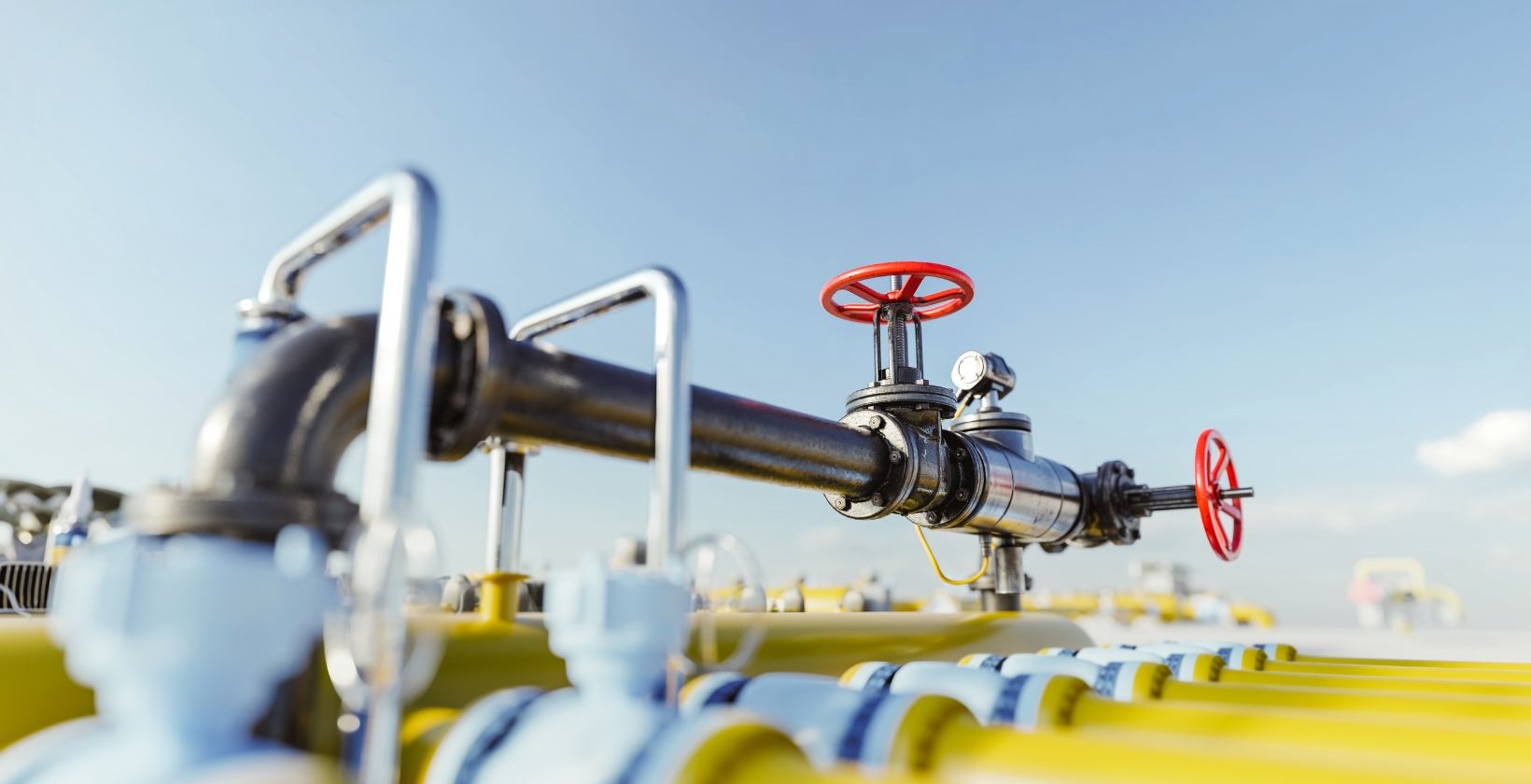 Gas hot tapping services UK Live gas pipeline with red handwheel isolation valves and a pressure gauge at a UK gas facility, ready for hot tapping